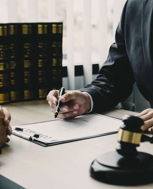 Lawyer hand holding pen and providing legal consult business dispute to the man.